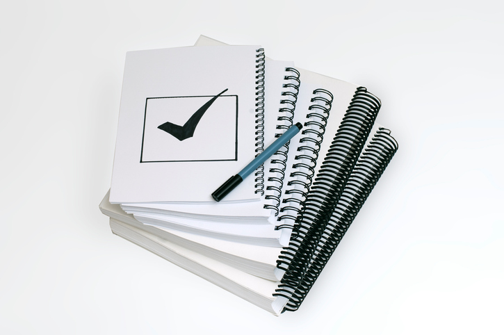 image of notebooks with a checkmark on the front
