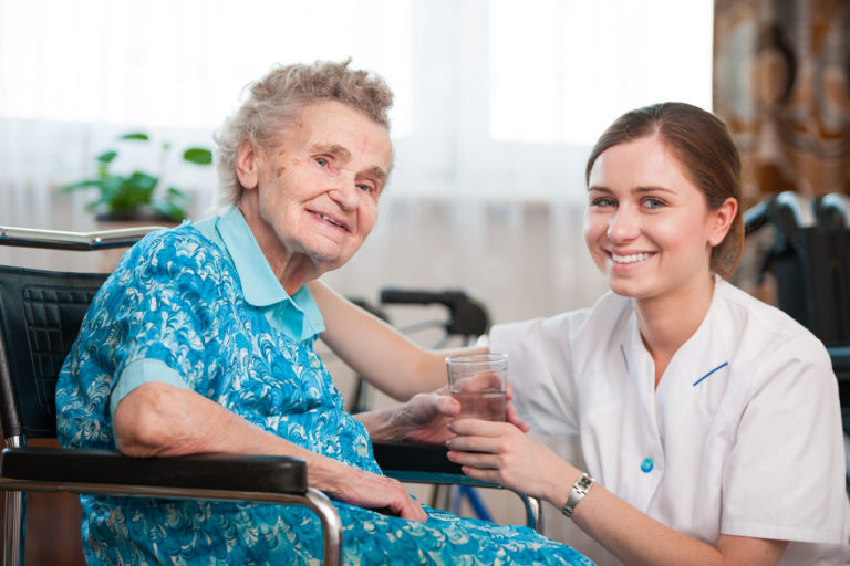 Nurse smiling with elderly patient
